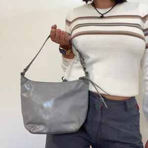 Gray patent leather Coach mini bag with silver hardware